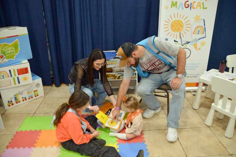 Santana and Daniel Mullins read to kids at the November 2025 Industrial Strength Bluegrass Festival - photo © Bill Warren
