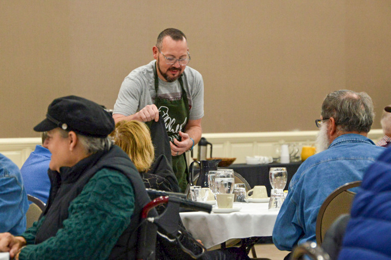 Adam McIntosh serving at the Saturday charity brunch at the November 2025 Industrial Strength Bluegrass Festival - photo © Bill Warren
