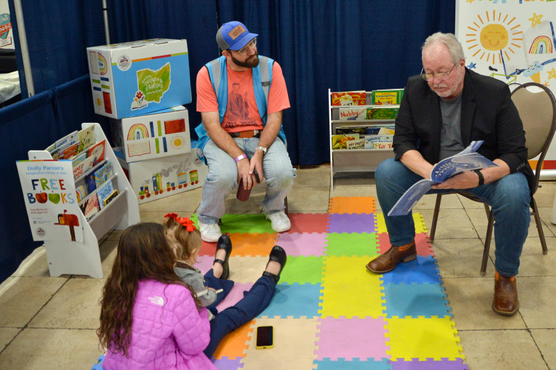 Daniel Mullins and Russell Moore read to kids at the November 2025 Industrial Strength Bluegrass Festival - photo © Bill Warren