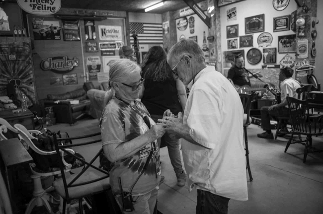 Nora Pitrolo gives a cancer support arm band to Robert Downy of The Bluegrass Brothers backstage at Pickin' in Parsons 2025 - photo © Jeromie Stephens