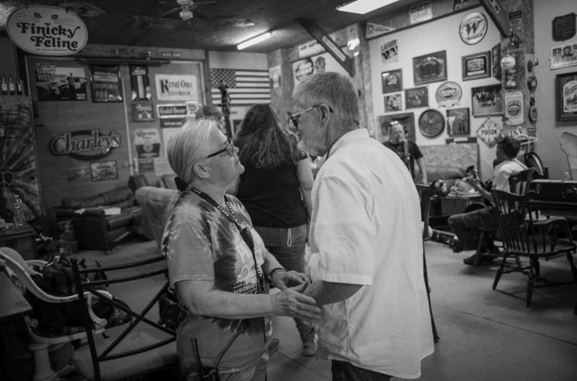 Nora Pitrolo gives a cancer support arm band to Robert Downy of The Bluegrass Brothers backstage at Pickin' in Parsons 2025 - photo © Jeromie Stephens