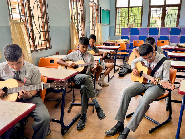 Guitar students at the Bluegrass Journeymen Academy at Triyog High School in Kathmandu, Nepal.
