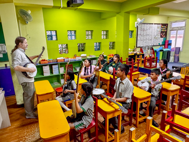 Max Winkels teaching banjo for the Bluegrass Journeymen Academy at Triyog High School in Kathmandu, Nepal.