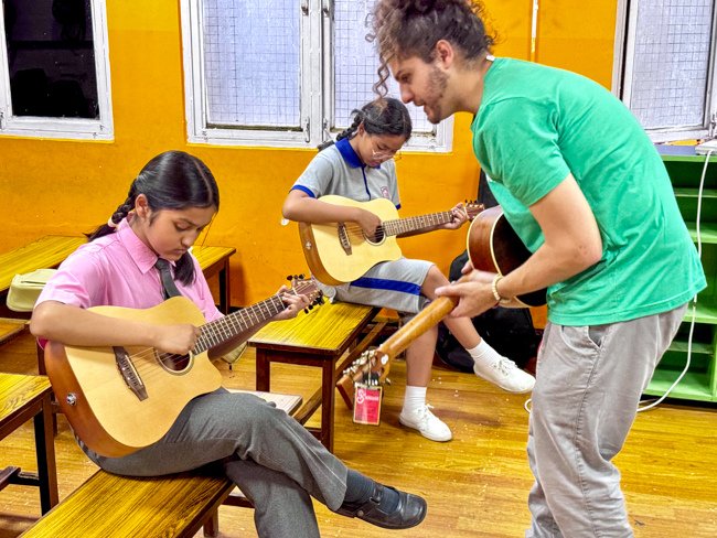 Chad Harris with guitar students at the Bluegrass Journeymen Academy at Triyog High School in Kathmandu, Nepal.
