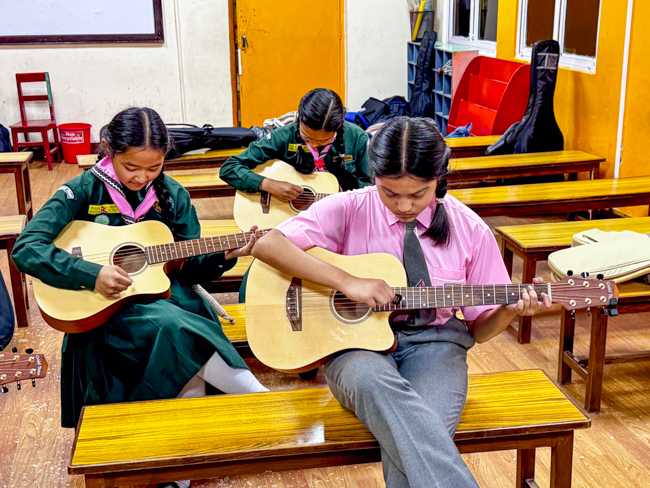 Guitar students at the Bluegrass Journeymen Academy at Triyog High School in Kathmandu, Nepal.